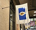 A variant of the flag seen in Metro Center, Springfield; note the absence of gold trim, banner with only gold and white, lighter blue, wider white field, and Puritan facing leftward