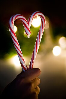 Two large candy canes, turned so they form a heart shape