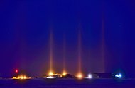 Nocturnal light pillars caused by light reflected through ice fog in Cambridge Bay, Nunavut, Canada