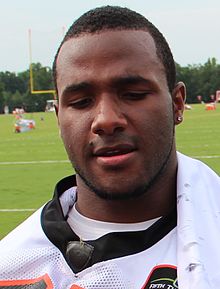 An American football player catching a football in mid-air.