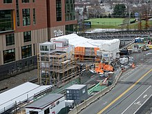 A railway station under construction in a railway cut