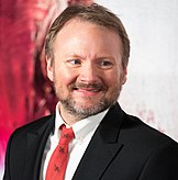 A picture of Rian Johnson smiling towards the camera