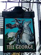 The sign depicts Saint George slaying a dragon.