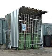 Bins of food waste locked in a cage