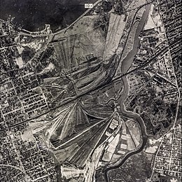 George Wilson and his wife Myrtle live in the "valley of ashes", a refuse dump (shown in the above photograph) historically located in New York City during the 1920s. Today, the area is Flushing Meadows–Corona Park.