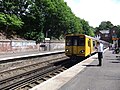 A Merseyrail Class 507 waits at the station.