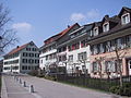 Häuserzeile vor der Bartholomäuskirche in Blickrichtung West, sie markiert den Verlauf der Kastellnordmauer, im Hintergrund das Schulgebäude