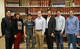 The Wikimedia DC Board of Directors in nice clothes standing in front of the Encyclopædia Britannica (with Gerald Shields far left).