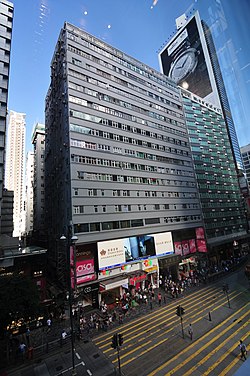 Front elevation of a 17-storey tenement building with street-level retail access