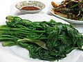 Eumnamu-sun-sukhoe (blanched tree aralia shoots) served with vinegar-gochujang mixture as dipping sauce