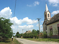 The main street in the village and the Saint Michael Archangel Catholic Church