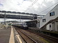 A view of platform 1. The East West Free Passage is ahead, the footbridge to the island platform is to the right.