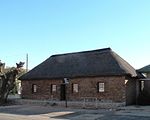 Single storey building of rectangular form. Built of banded ironstone with thatched hipped roof. S It was here that Mary Moffat, daughter of the missionary Robert Moffat was born. It is the same buil[clarification needed] Type of site: House Previous use: Residential : Single - Commercial : Bank. Current use: Museum. The building was built in the first half of the 19th century when Griquatown was the main cent