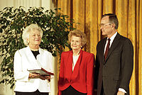 Betty Ford being awarded the nation's highest civilian honor, the Presidential Medal of Freedom, by President George H. W. Bush, 1991. First Lady Barbara Bush is holding the medal.