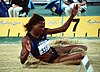 Photo of Burrell jumping into a sandpit at the 2000 Olympic Games