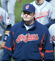 A man in a navy blue jacket and cap