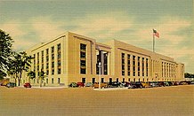 A postcard of an art deco/stripped classical building viewed from the corner