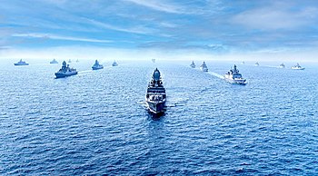 Smaller ships escorting two large ones