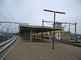 Platform level looking southwards, with a train in the direction of Weesp (centre) and Sprinter from the direction of Utrecht on the extreme right of the image.