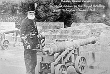 Turner, an old man with a white beard in military uniform, standing by a cannon. The picture is labelled "the oldest man in the Royal Artillery"