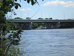 A wide box girder structure on massive concrete pillars.