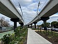 Elevated rail and landscaping leading to Preston station built by the Level Crossing Removal Project, July 2023