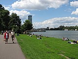 People sunbathing along the Spree River in Treptow