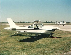 A low winged single-engined aircraft parked