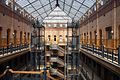 HABS interior photograph of the central court of the Bradbury Building, emphasizing the ornamental ironwork on the stairways and open walkways and the large skylight.