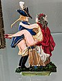French painted metal figurine, c 1900, showing a Chevalier seducing his mistress on a campaign drum
