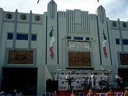 photo of main entrance with band and cheerleaders