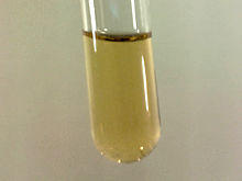 Small sample of pale yellow liquid fluorine condensed in liquid nitrogen
