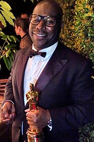 Steve McQueen holding the trophy for Best Picture Oscar for the film at the 86th Academy Awards