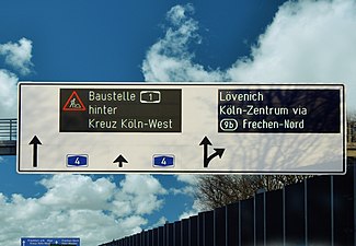 A row matrix LED sign on an interchange of a German Autobahn with side graphics display.