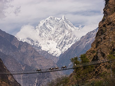 A peak in the Nilgiri Himal mountains backdrops this shot of a simple suspension bridge over the Gandaki River in Nepal. Photo by Faj2323