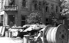 Barricade erected such on Napoleon Square. In background: captured Hetzer tank destroyer. 3 August 1944