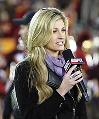 Erin Andrews holds a microphone as she speaks