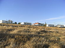 Five residential buildings overlooking scrub grass