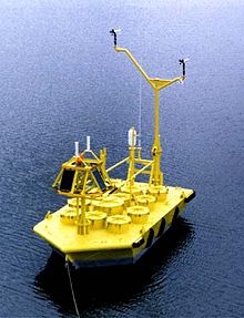 A yellow 6-m NOMAD anchored in calm ocean waters