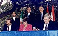 Image 44Three world leaders: (background, left to right) Mexican President Carlos Salinas de Gortari, U.S. President George H. W. Bush, and Canadian Prime Minister Brian Mulroney, observe the signing of the North American Free Trade Agreement. (from History of Mexico)