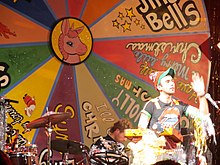 Stevens performing in front of a large song wheel