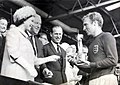 The British queen Elizabeth II presents the 1966 Football World Cup to England Captain, Bobby Moore