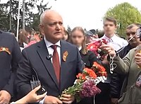 Moldovan former president Igor Dodon (wearing the Ribbon of Saint George) with members of the Șor Party at a Victory Day rally in Moldova on 9 May 2023