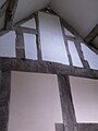16th-century timber framing seen inside the entrance hall, formerly part of an undivided 16th-century hall.