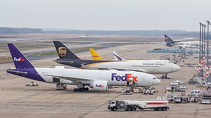 FedEx, United Parcel Service and DHL cargo airplanes at Cologne Bonn Airport. In the foreground an Exxon tank truck.