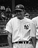 A photo of baseball player Lou Gehrig in the pinstriped uniform of the New York Yankees in the foreground, with fans in the stands in the background