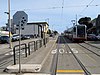 A train passes the outbound platform at Judah and 46th Avenue station, 2018