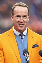 Man in orange blazer headshot