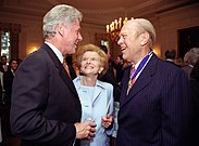 President Bill Clinton speaking with the Fords at the White House ceremony awarding the at a 1999 Presidential Medal of Freedom ceremony