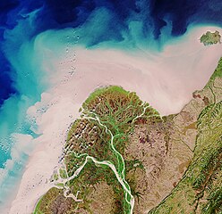 River discharge in the Yukon Delta, Alaska. The pale color demonstrates the large amounts of sediment released into the ocean via the rivers.